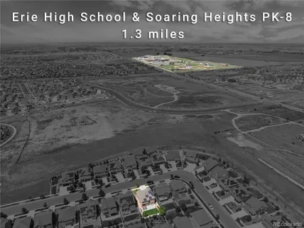 a front view of a house with a yard and potted plants