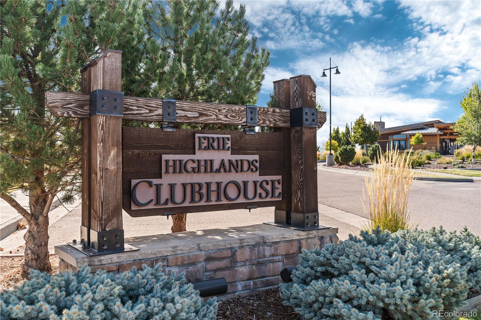 1074 Acadia Circle Erie, CO 80516 - Photo 41 of 50 a view of a street sign under a large tree