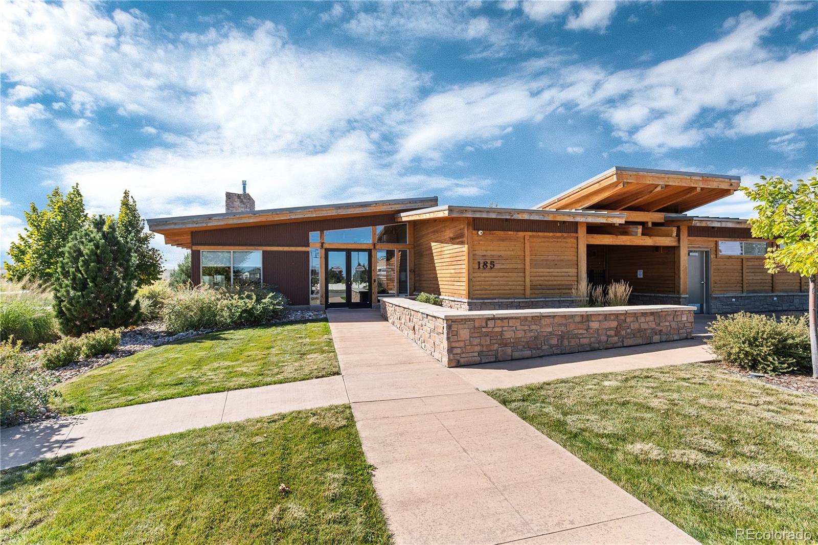 1074 Acadia Circle Erie, CO 80516 - Photo 42 of 50 a front view of a house with a yard and potted plants