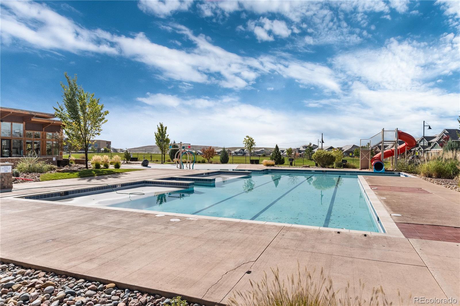 1074 Acadia Circle Erie, CO 80516 - Photo 44 of 50 a view of swimming pool with outdoor seating and city view