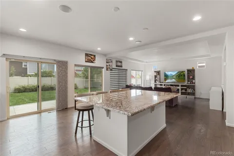 a dining hall with stainless steel appliances granite countertop a granite counter tops and a large window