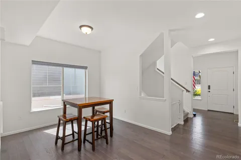 a dining room with furniture and wooden floor