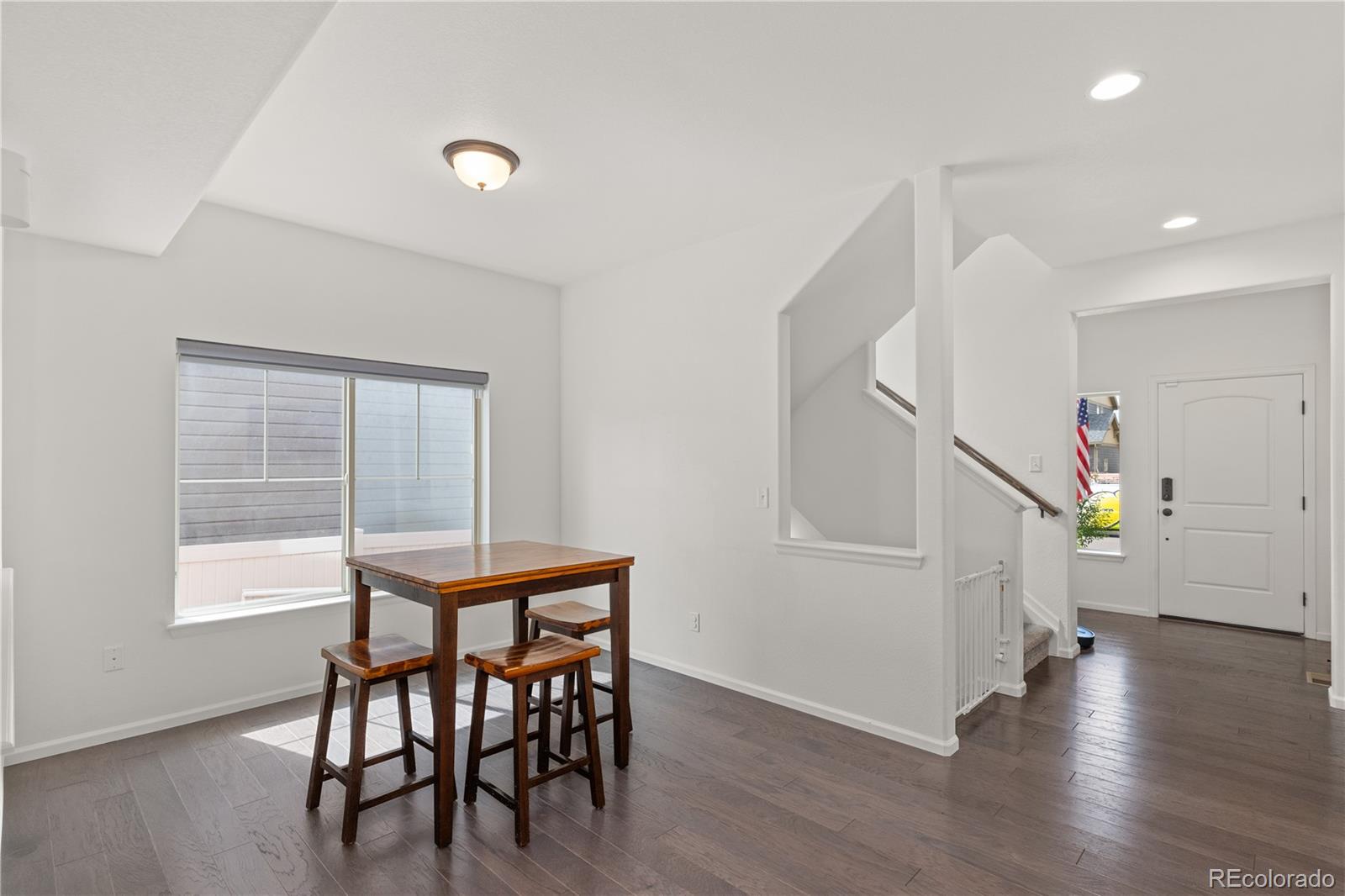 1074 Acadia Circle Erie, CO 80516 - Photo 9 of 50 a dining room with furniture and wooden floor