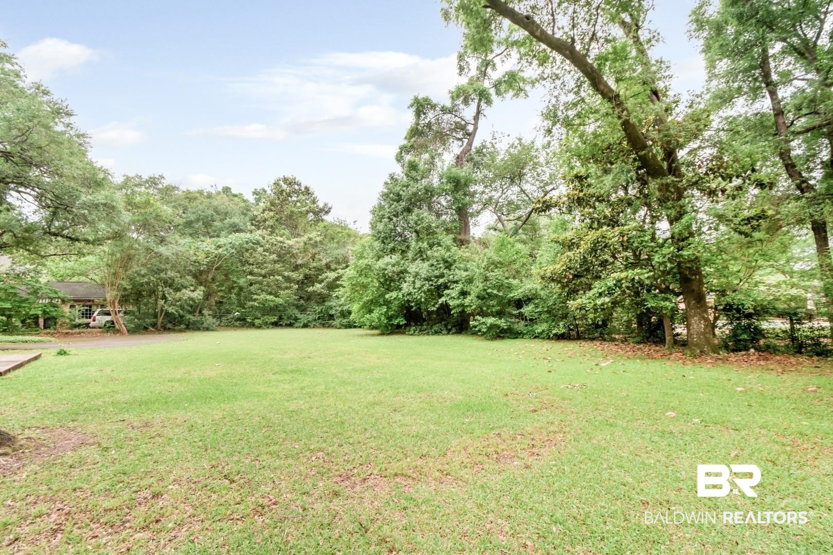 4596 Hawthorne Place Mobile, AL 36608 - Photo 30 of 34 Expansive green lawn surrounded by mature trees