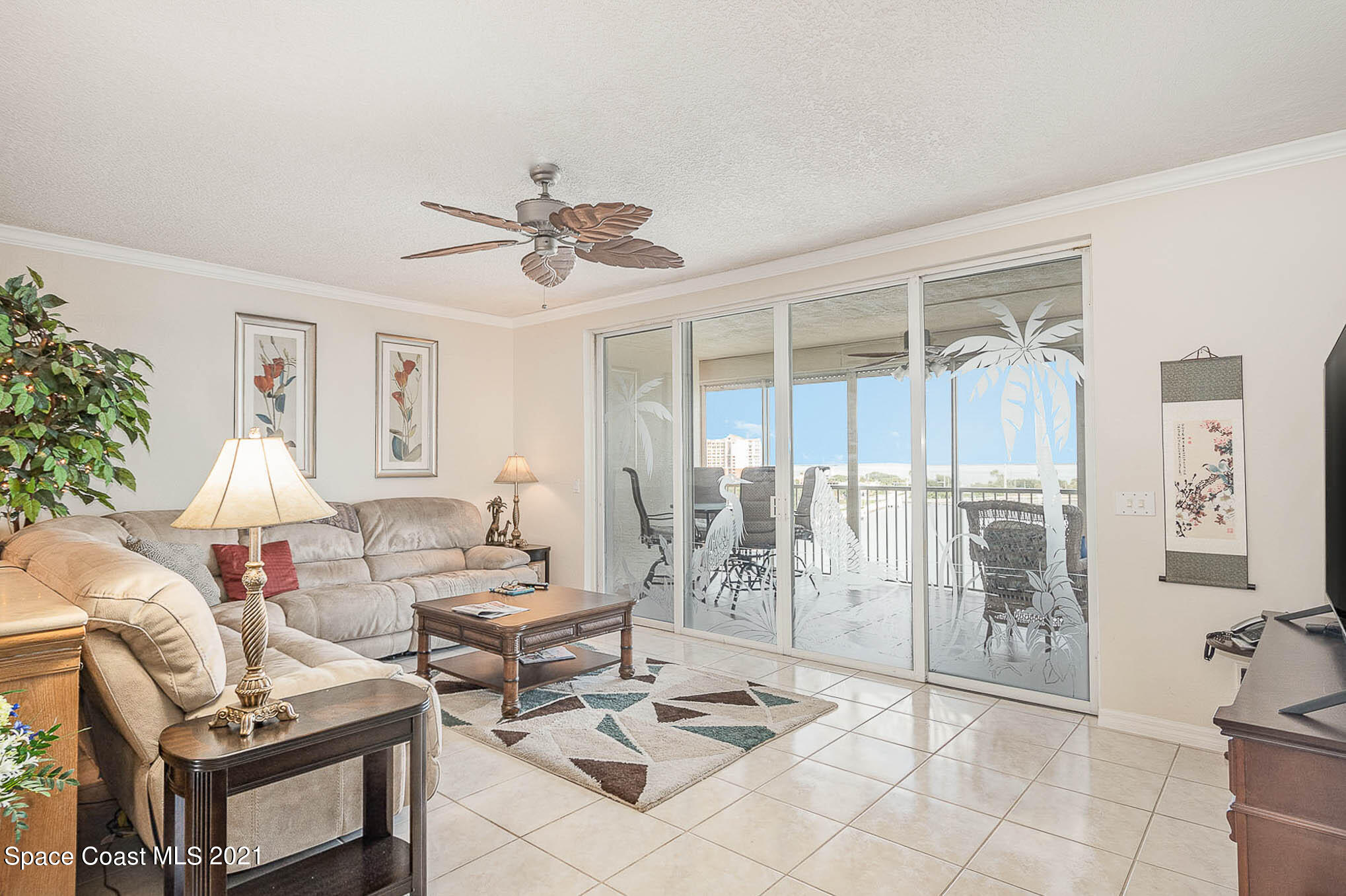 100 Riverside Drive, Unit 705 Cocoa, FL 32922 - Photo 11 of 39 a living room with furniture a table and a chandelier