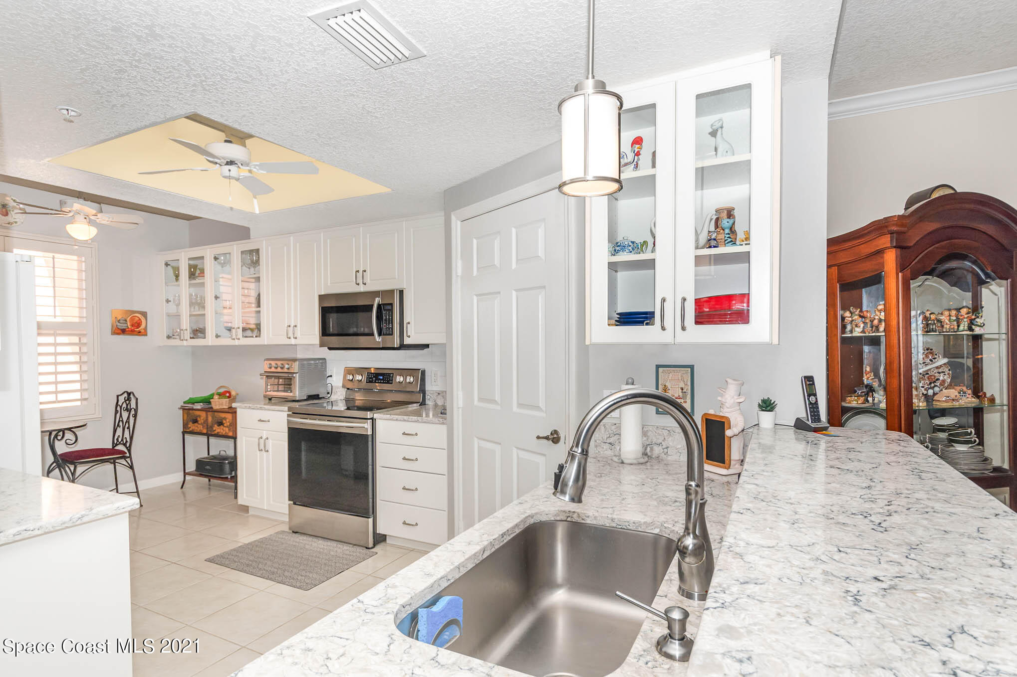 100 Riverside Drive, Unit 705 Cocoa, FL 32922 - Photo 15 of 39 a kitchen with stainless steel appliances granite countertop a sink and a stove top oven
