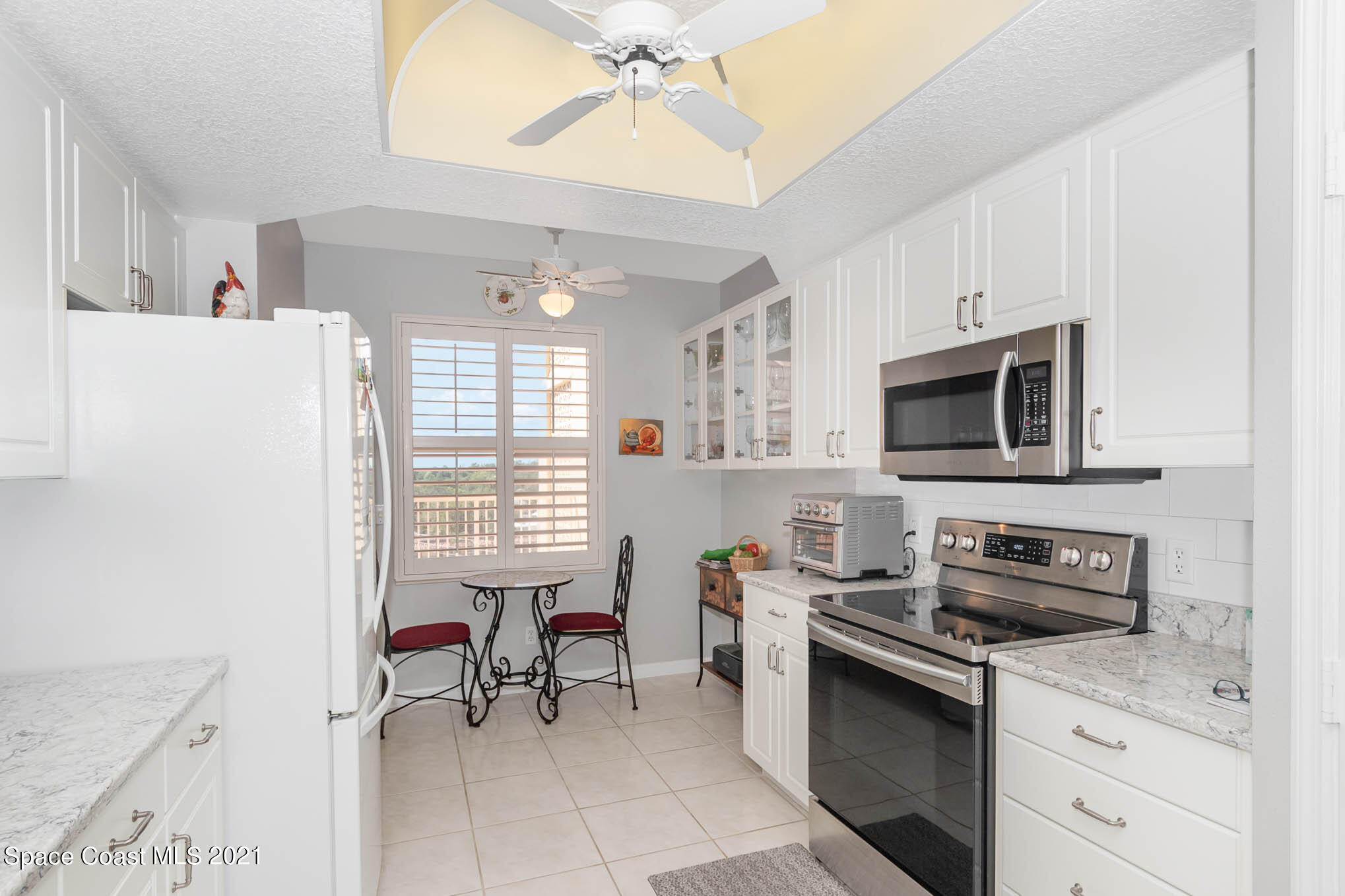 100 Riverside Drive, Unit 705 Cocoa, FL 32922 - Photo 16 of 39 a kitchen with stainless steel appliances a stove a sink and a refrigerator