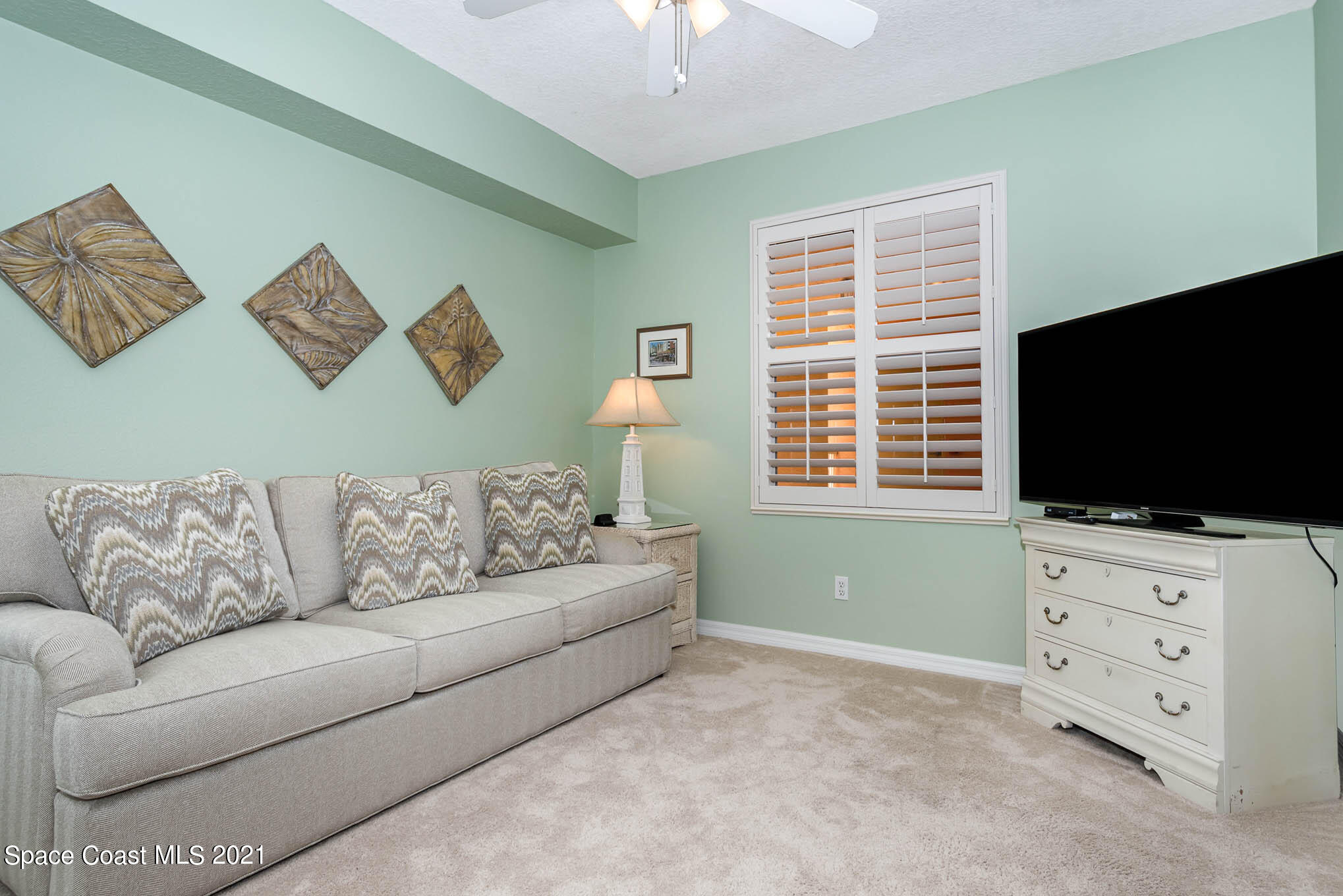 100 Riverside Drive, Unit 705 Cocoa, FL 32922 - Photo 25 of 39 a living room with furniture and a flat screen tv