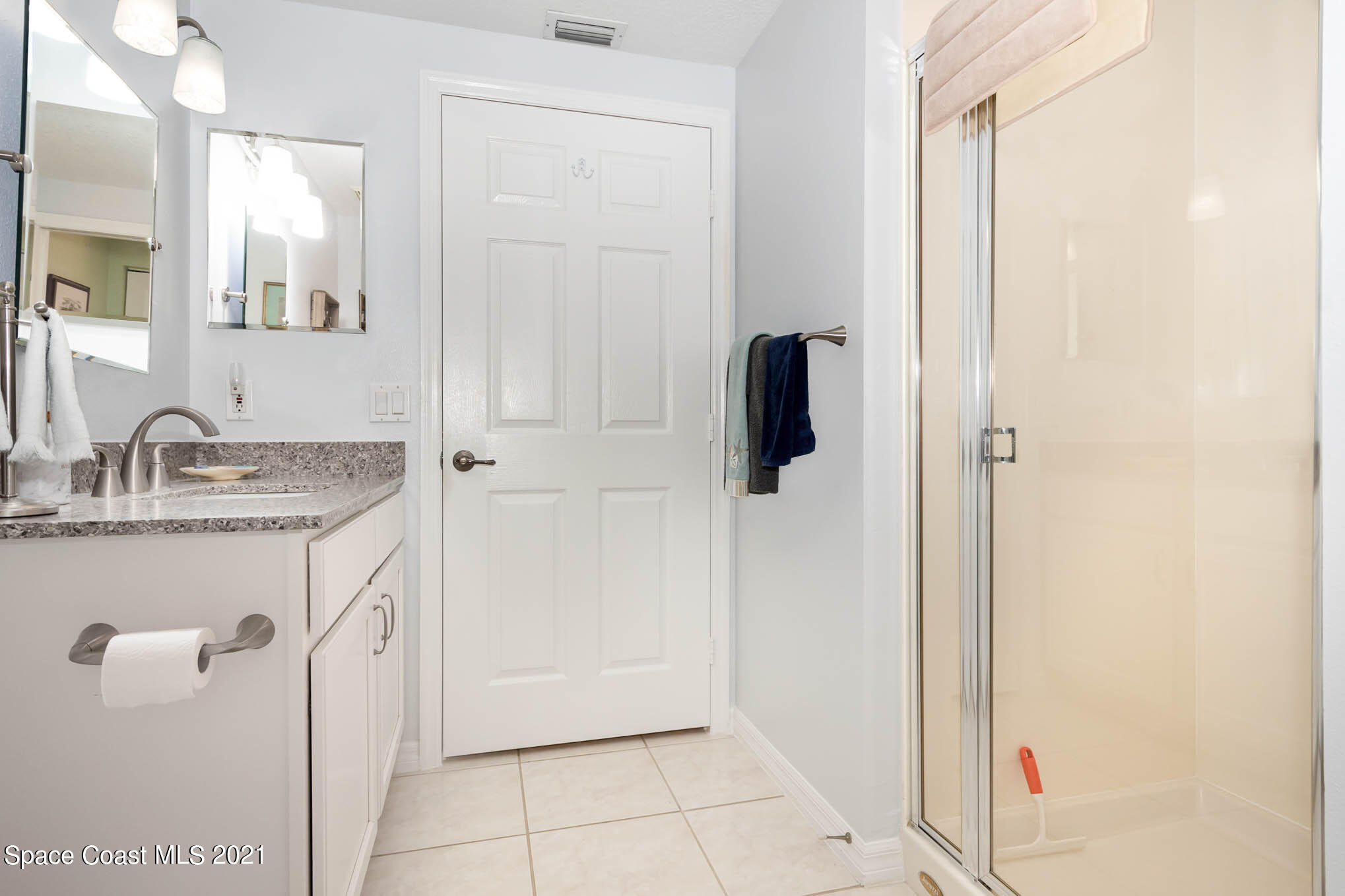 100 Riverside Drive, Unit 705 Cocoa, FL 32922 - Photo 28 of 39 a bathroom with a granite countertop sink and a mirror