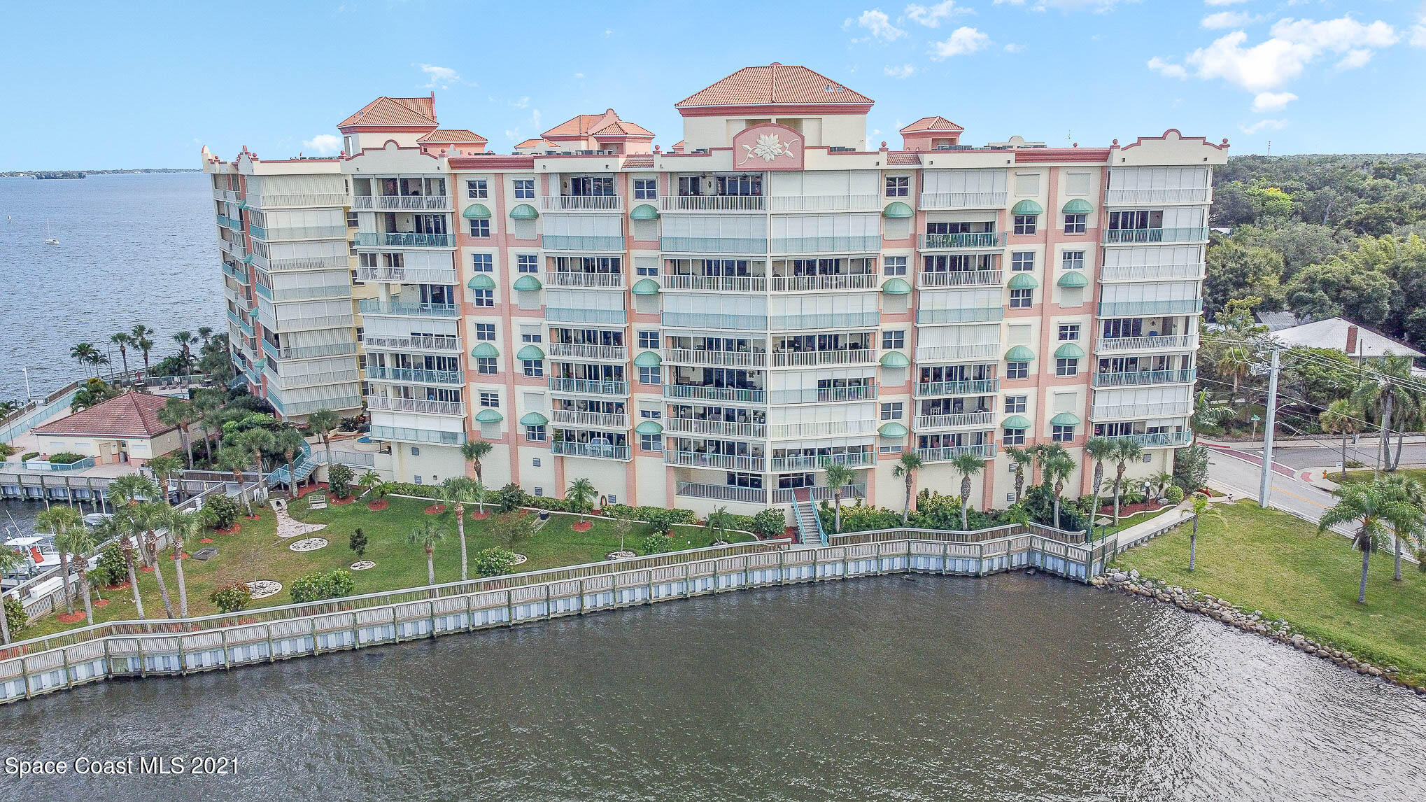 100 Riverside Drive, Unit 705 Cocoa, FL 32922 - Photo 7 of 39 a front view of a building with a garden and plants