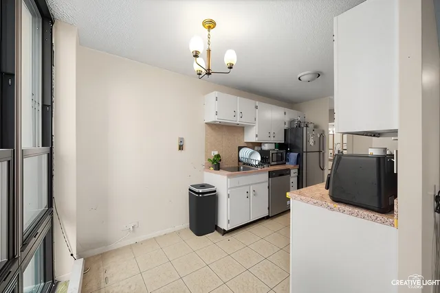 a kitchen with cabinets and stainless steel appliances