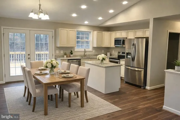 a kitchen with a table chairs refrigerator microwave and cabinets