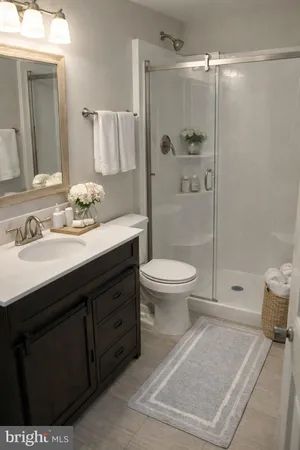 a bedroom with a bed and a dresser next to a window