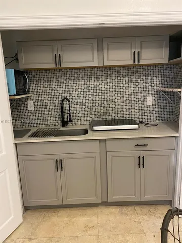 a kitchen with a sink and cabinets