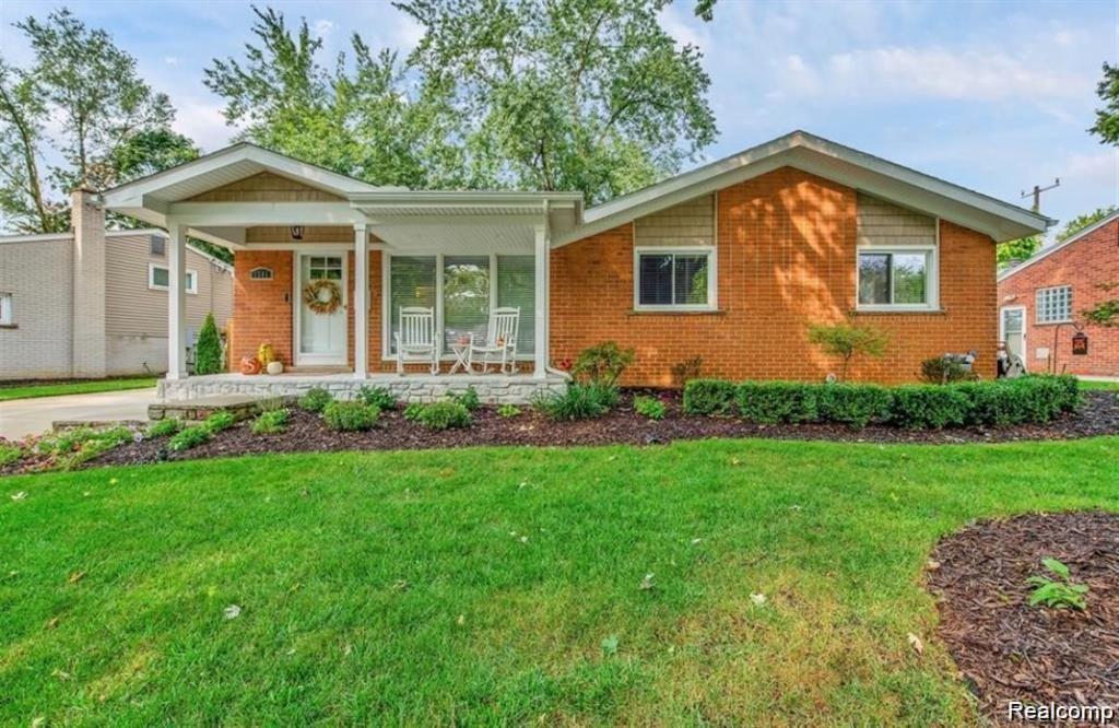 1341 Catalpa Drive Rochester, MI 48307 - Photo 1 of 9 Brick ranch-style residence featuring a welcoming covered front porch, an expansive front lawn, and established landscaping with mature trees