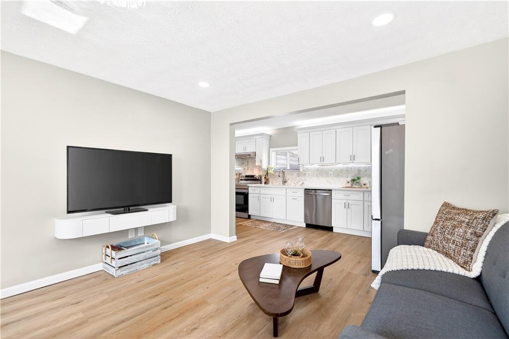 731 Chartiers Street Bridgeville, PA 15017 - Photo 11 of 48 a living room with furniture and a flat screen tv