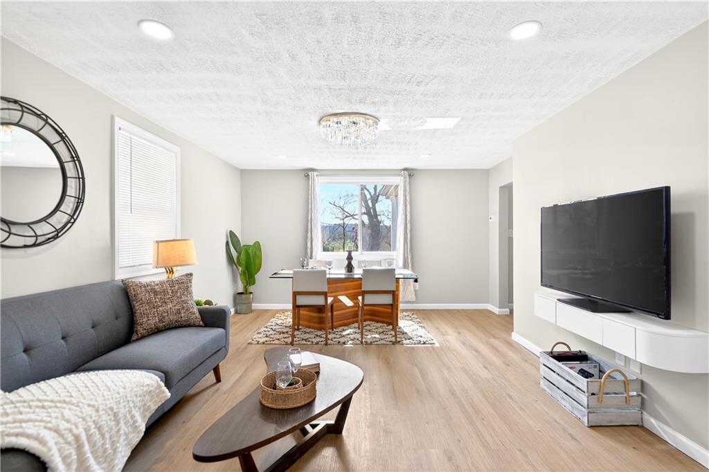 731 Chartiers Street Bridgeville, PA 15017 - Photo 13 of 48 a living room with furniture and a flat screen tv