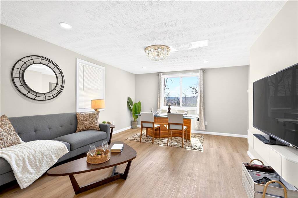 731 Chartiers Street Bridgeville, PA 15017 - Photo 14 of 48 a living room with furniture and a flat screen tv