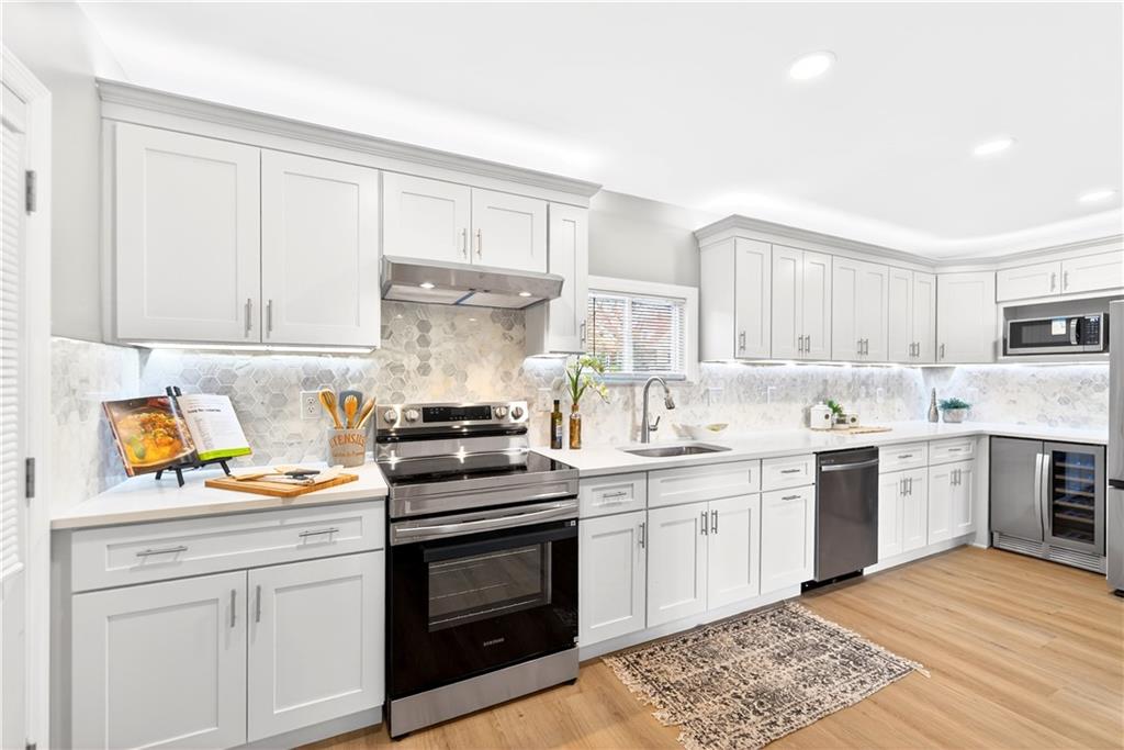 731 Chartiers Street Bridgeville, PA 15017 - Photo 15 of 48 a kitchen with a stove cabinets and wooden floor