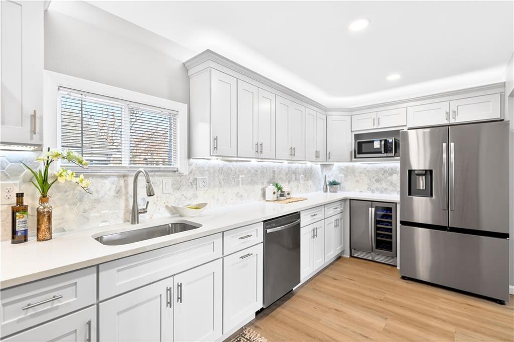 731 Chartiers Street Bridgeville, PA 15017 - Photo 16 of 48 a kitchen with a refrigerator sink and white cabinets