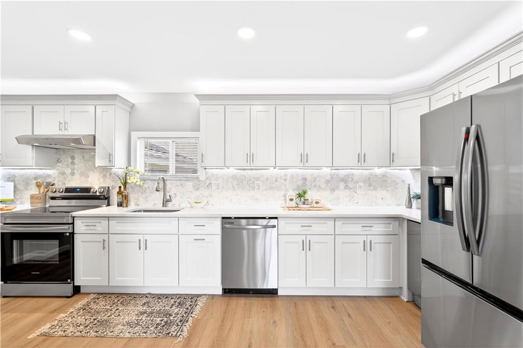 731 Chartiers Street Bridgeville, PA 15017 - Photo 17 of 48 a kitchen with a sink cabinets stainless steel appliances and a window