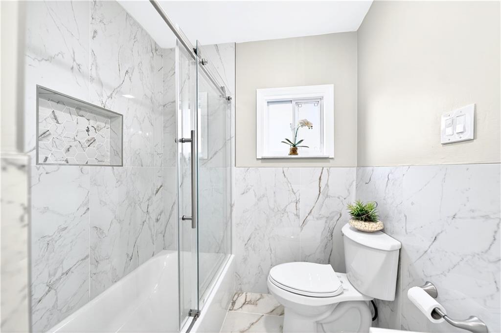 731 Chartiers Street Bridgeville, PA 15017 - Photo 21 of 48 a white toilet sitting next to a bath tub