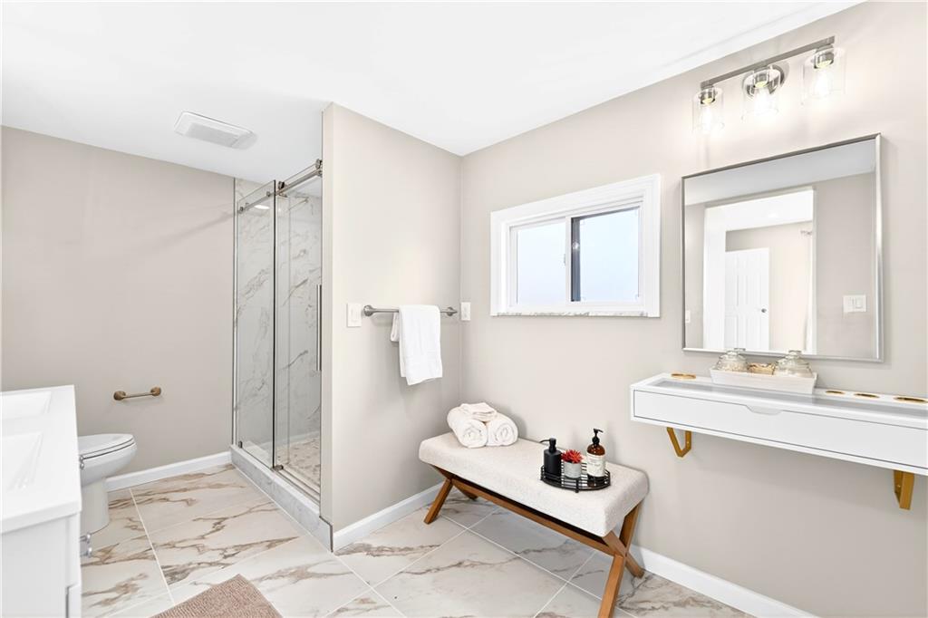 731 Chartiers Street Bridgeville, PA 15017 - Photo 29 of 48 a bathroom with a sink a toilet and a mirror