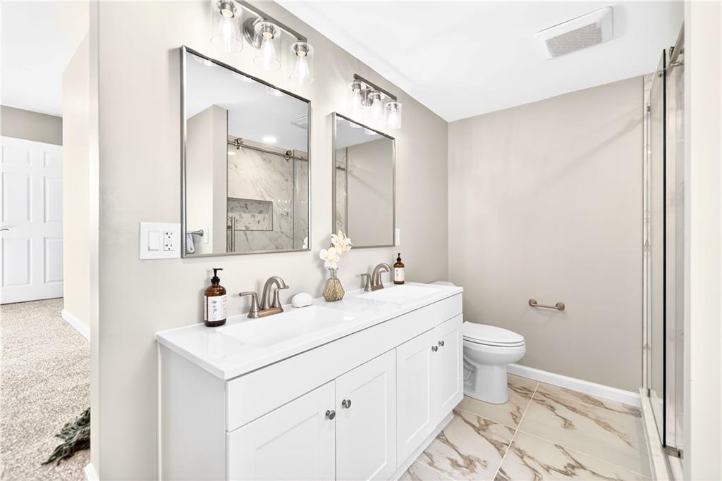 731 Chartiers Street Bridgeville, PA 15017 - Photo 31 of 48 a bathroom with a sink a toilet and a mirror