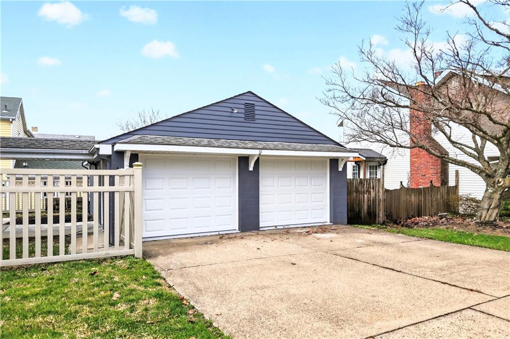 731 Chartiers Street Bridgeville, PA 15017 - Photo 47 of 48 a front view of a house with a yard and garage