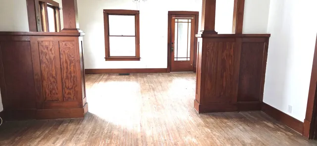 a view of a livingroom with wooden floor and a window