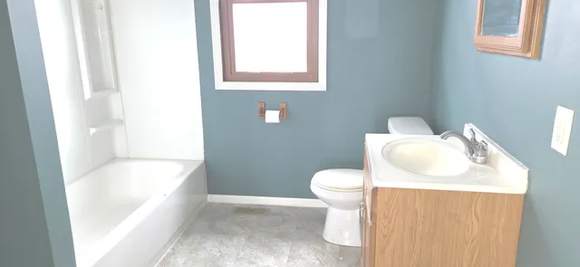 a living room with a fireplace and a window