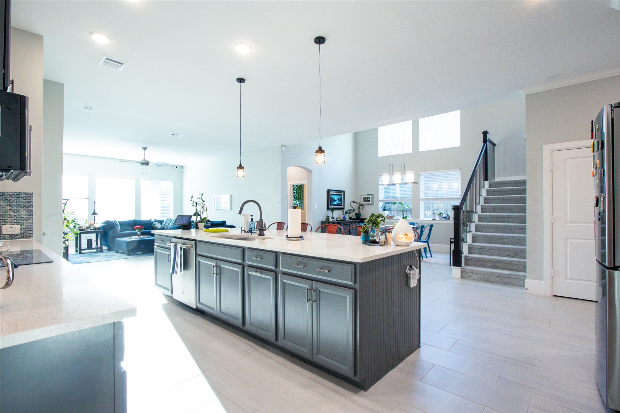 a large kitchen with kitchen island a large counter top a sink a window and appliances