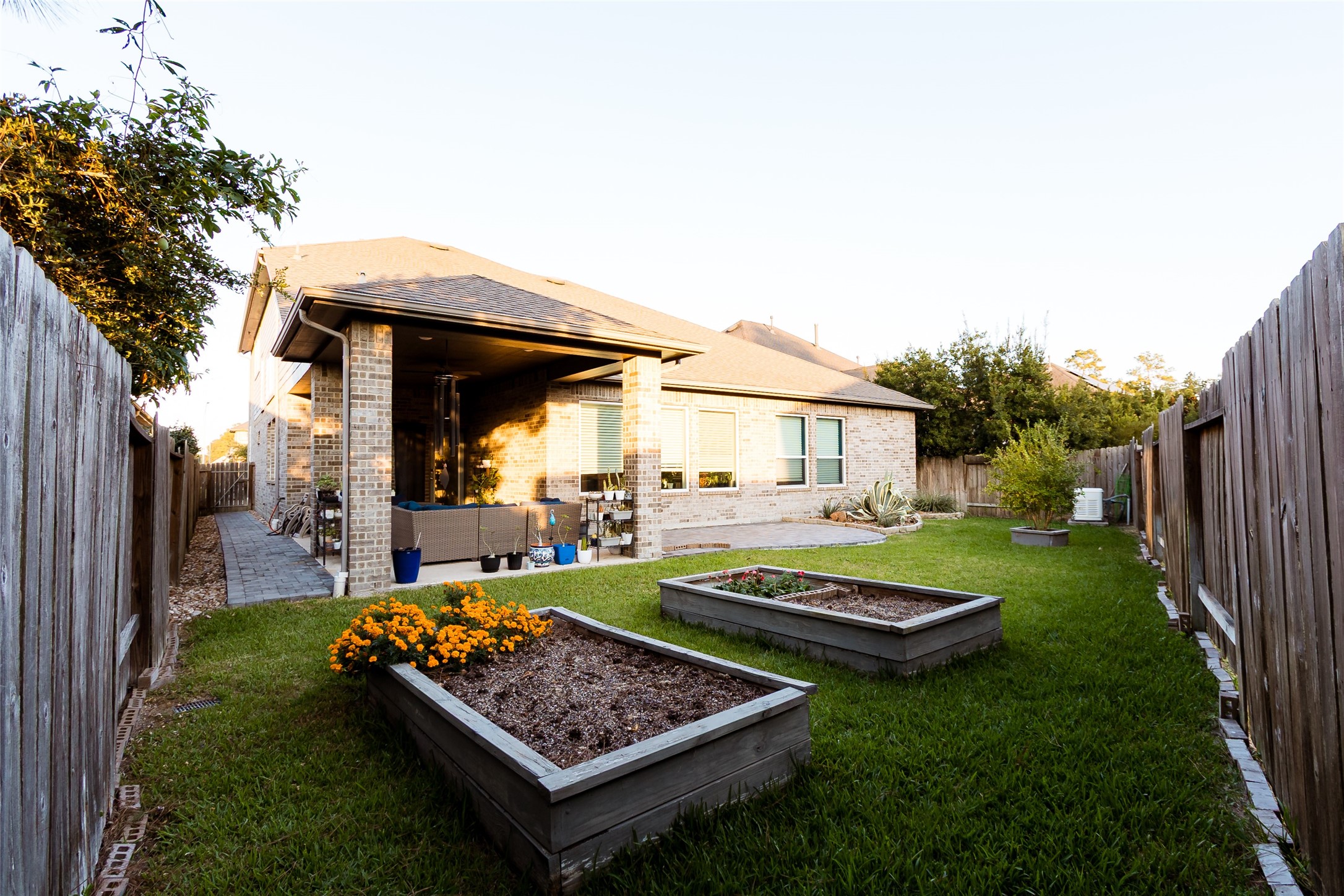 32106 Aspen Grove Court Spring, TX 77386 - Photo 18 of 28 a view of a backyard with table and chairs potted plants and wooden fence