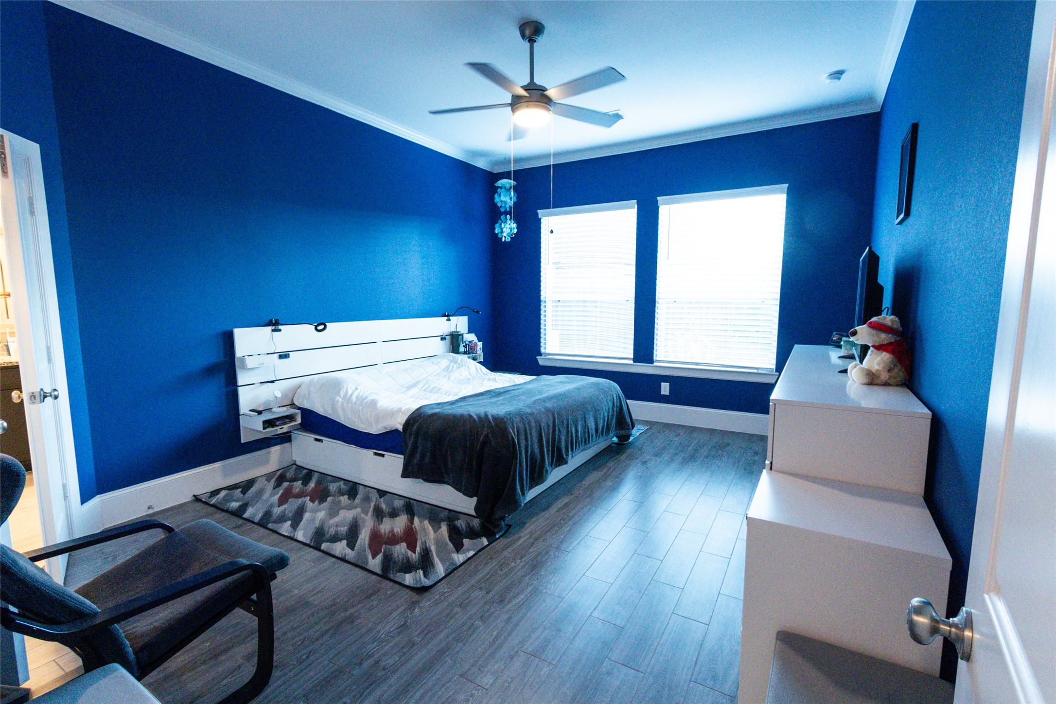 32106 Aspen Grove Court Spring, TX 77386 - Photo 7 of 28 a bedroom with a bed and a chandelier