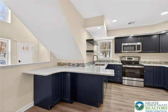 a bathroom with a granite countertop toilet a sink and a mirror