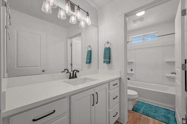 1693 North Center Point Lane Salem, UT 84653 - Photo 16 of 26 Bathroom featuring a wide vanity with a solid surface countertop and undermount sink, shaker-style cabinetry with matte black hardware, and a framed mirror with a modern light fixture
