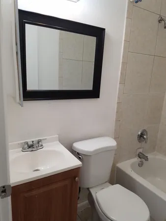 a white toilet sitting next to a bathroom sink