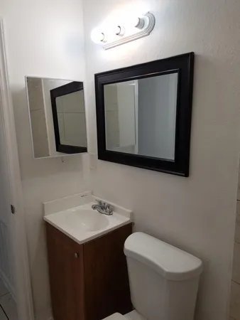 a white toilet sitting next to a bathroom sink