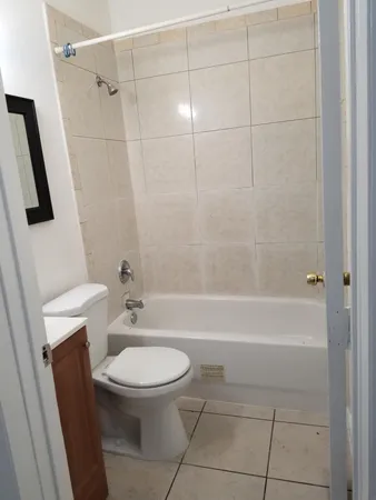 a bathroom with a toilet a sink and bathtub