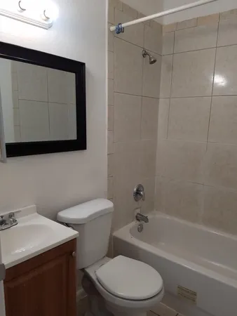a bathroom with a toilet a sink and bathtub