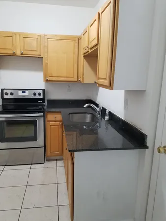 a close view of sink and cabinets