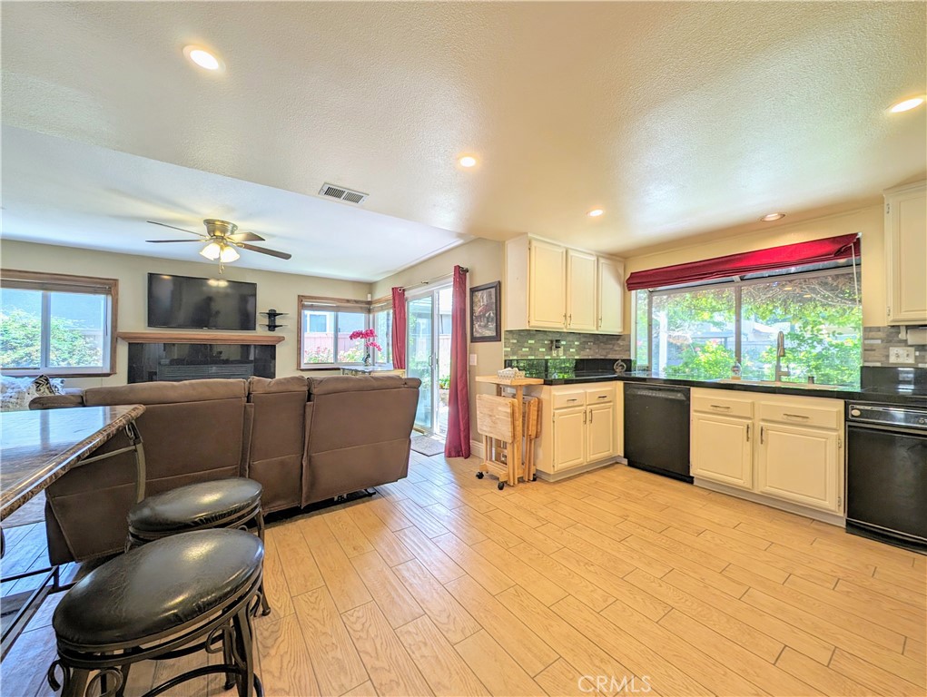 1738 Cambridge Circle Redlands, CA 92374 - Photo 18 of 59 a kitchen with stainless steel appliances kitchen island granite countertop a table and chairs in it