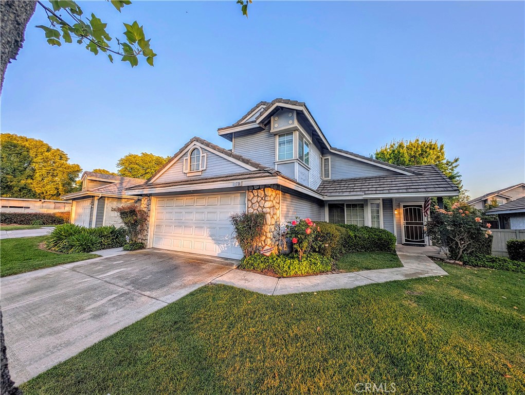 1738 Cambridge Circle Redlands, CA 92374 - Photo 2 of 59 a front view of a house with a garden and yard