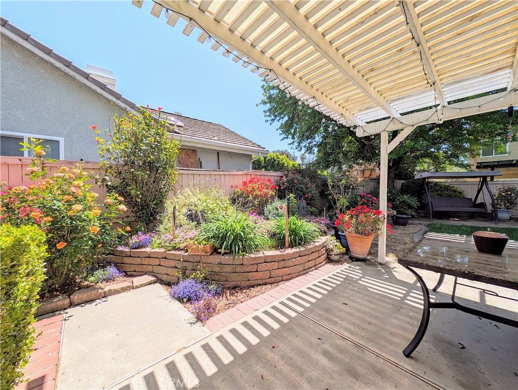 1738 Cambridge Circle Redlands, CA 92374 - Photo 25 of 59 a patio with table and chairs and potted plants