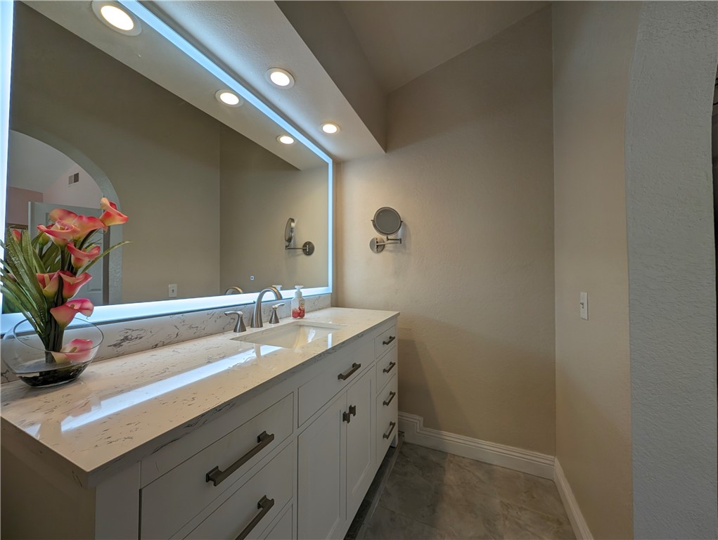 1738 Cambridge Circle Redlands, CA 92374 - Photo 35 of 59 a bathroom with a sink and a mirror