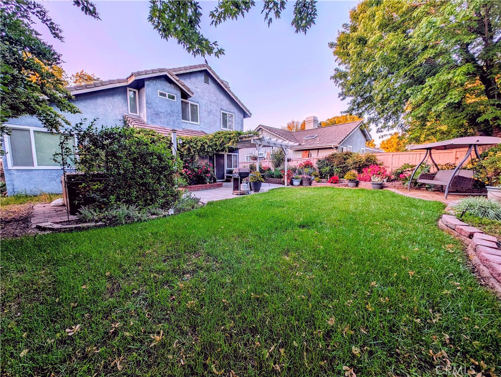 1738 Cambridge Circle Redlands, CA 92374 - Photo 6 of 59 a view of a garden with a house in the background