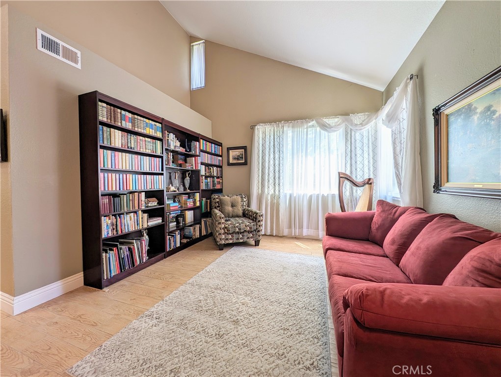 1738 Cambridge Circle Redlands, CA 92374 - Photo 9 of 59 a living room with furniture and a large window with bookshelf