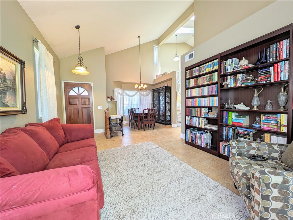 1738 Cambridge Circle Redlands, CA 92374 - Photo 10 of 59 a living room with furniture and a book shelf