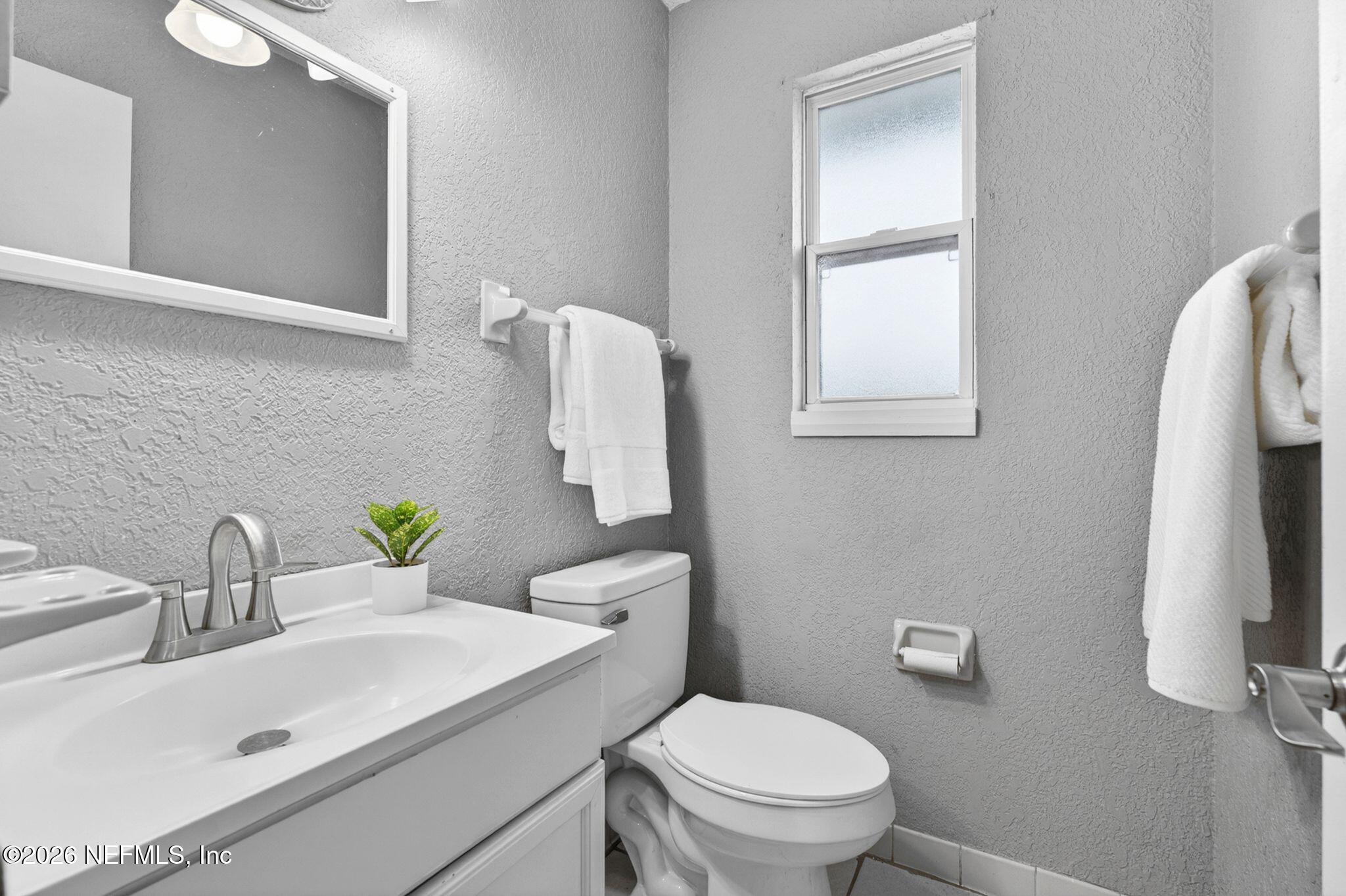 138 Ridgefield Court Orange Park, FL 32065 - Photo 25 of 64 a bathroom with a sink toilet and mirror