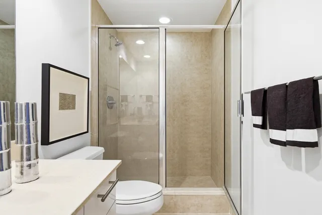 a bathroom with a shower a toilet and a sink